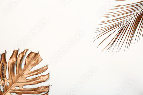 Painted Monstera and Date palm tropical leaves with space for text on white background, top view