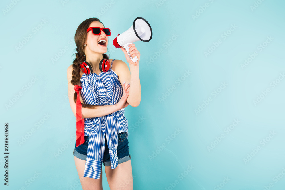 Young sexy woman with headphones and loudspeaker Young sexy woman with headphones and loudspeaker