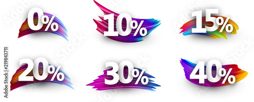 Discount tags with percent and colorful brush strokes.