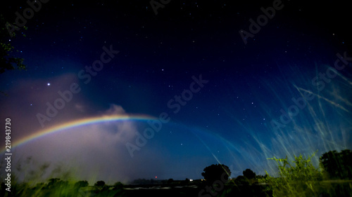 A lunar rainbow(Moonbow) at night, Victoria Falls, Zambia, Africa