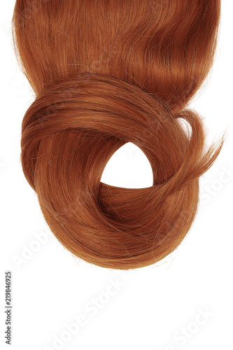 Henna hair isolated on white background. Long beautiful ponytail in shape of circle