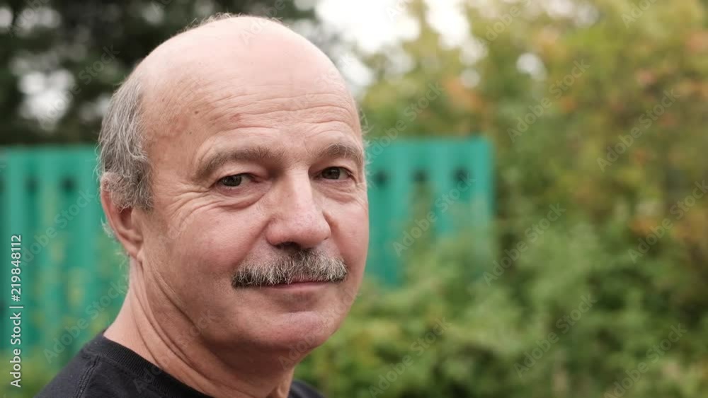 Happy mature man smiling. Outdoor and close up view. Happy mature man smiling. Outdoor and close up view.