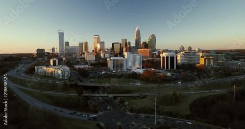 Wide aerial, sunset over Charlotte skyline