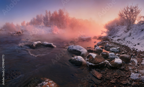 Obraz na płótnie Winter Landscape In Pink Tones: Frosty Morning, River Blurred Water,Stones In Frazil And Sun In Fog.Belarus Landscape With Snowy Trees, Beautiful Frozen Foggy River And Winter Forest At Sunrise. w salonie