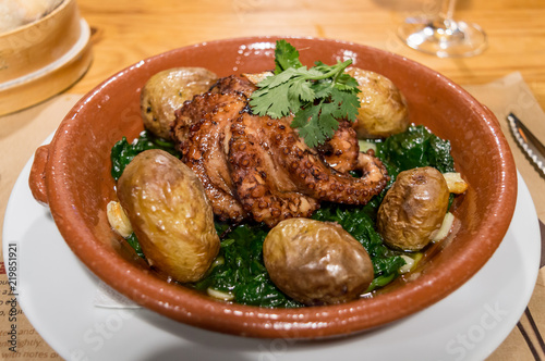 Typical plate from Portugal, octopus a lagareiro with potatoes and spinach