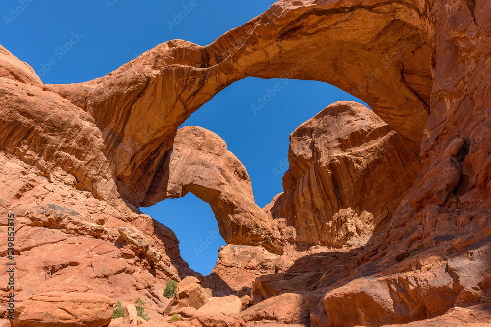 Double Arch - A close-up low-angle view of Double Arch, Arches National Park, Utah, USA. 