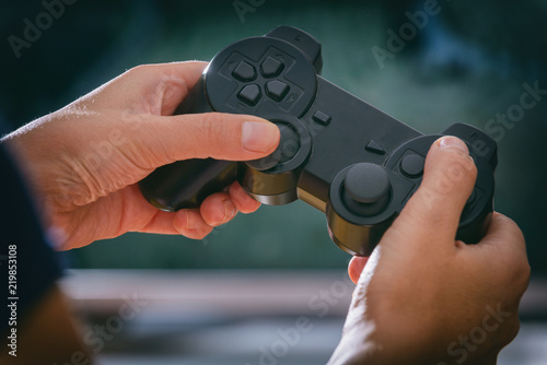 Woman plays video game using the gamepad