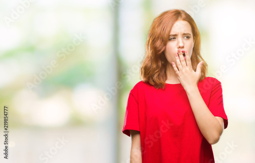 Young beautiful woman over isolated background bored yawning tired covering mouth with hand. Restless and sleepiness.