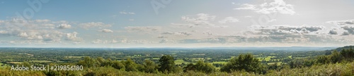 Panoramic view of the Surrey and Sussex countryside from the North Downs to the South Downs in England, UK. Taken from the Iron Age Hill Fort on top of Holmbury Hill on a cloudy summer's day.