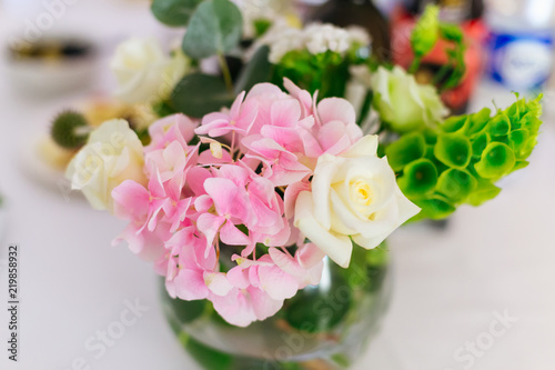 A close-up of pink flowers and white roses in a beautiful flower