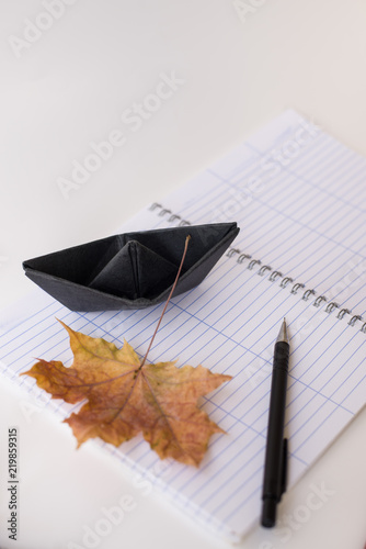 background with a clean notebook in line which placed diagonally and maple leaf