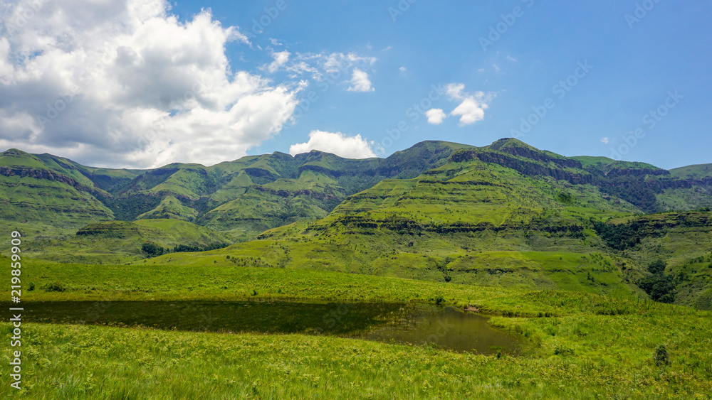 Rich nature with grass and mountains, clouds, in Drakensberg Giant Castle, South Africa 