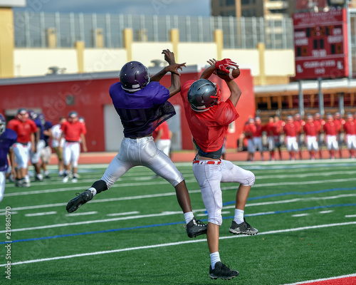Football player receiver jumping in the air to make a catch
