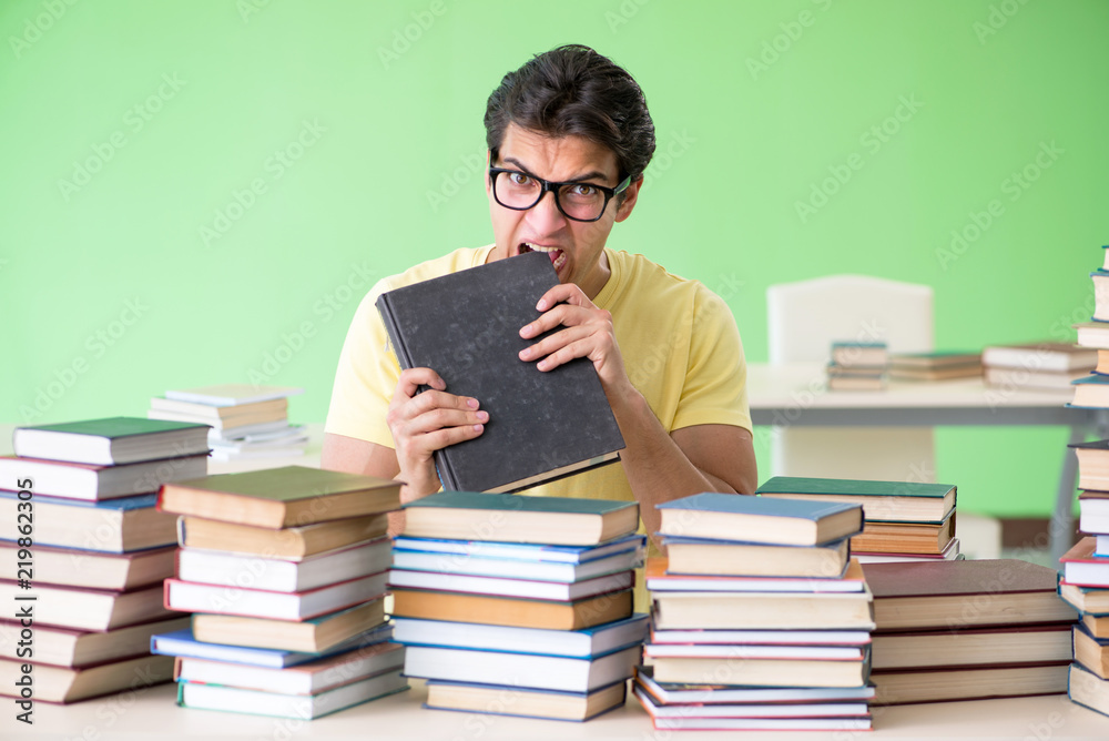 Student with too many books to read before exam Student with too many books to read before exam