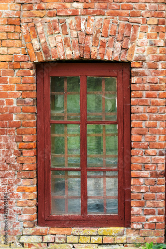 an image of old window on red brick wall