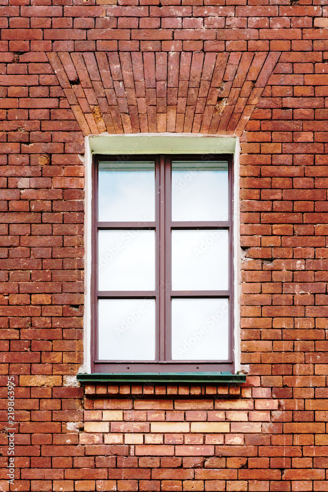 an image of old window on red brick wall