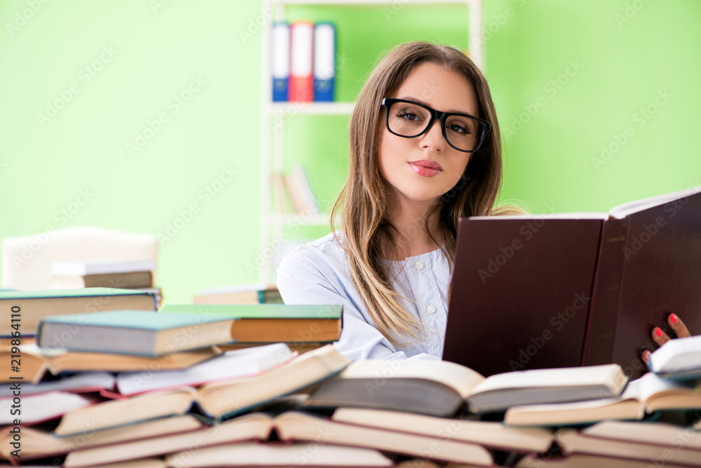 Young female student preparing for exams with many books Young female student preparing for exams with many books