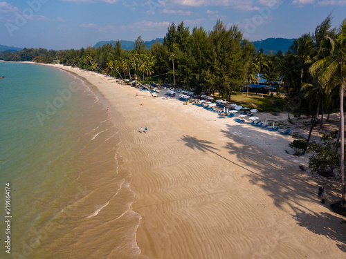 Aerial view of late afternoon shadows being cast onto a beautiful tropical sandy beach in Thailand  Coconut Beach  Khao Lak 