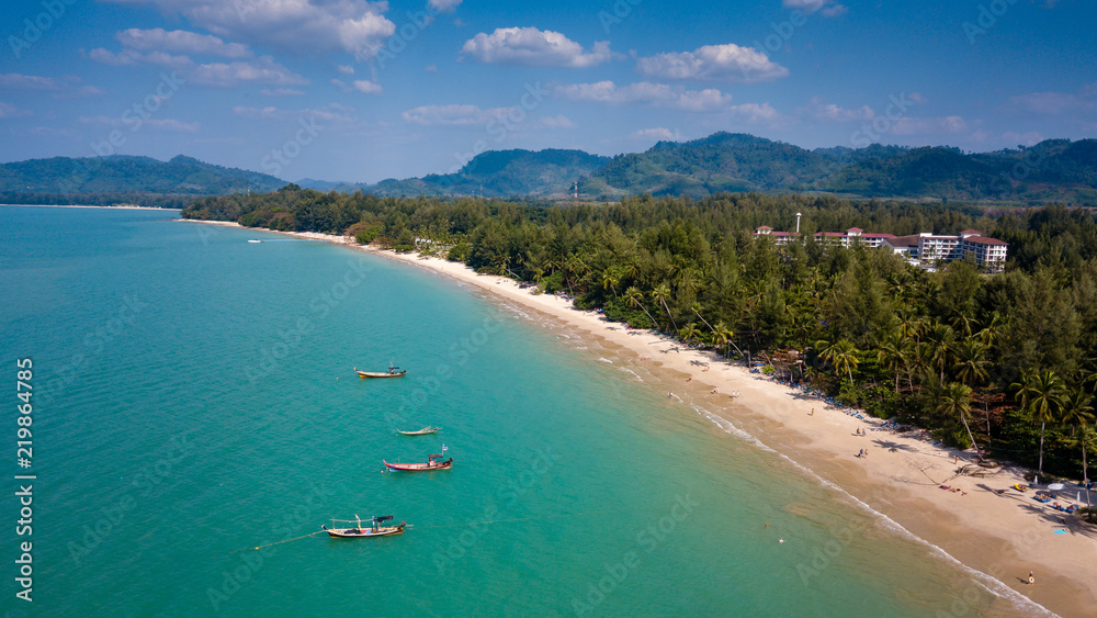 Aerial drone view of a beautiful empty sandy beach and tropical coastline Aerial drone view of a beautiful empty sandy beach and tropical coastline