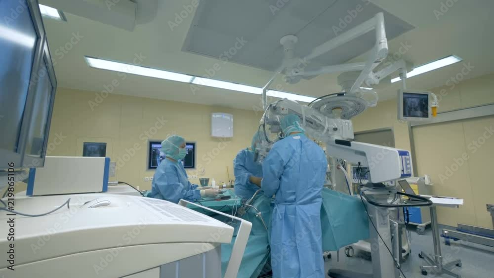 Many surgeons in an operating room, close up.
