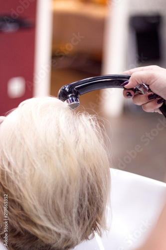 Hairdresser washing a clients head