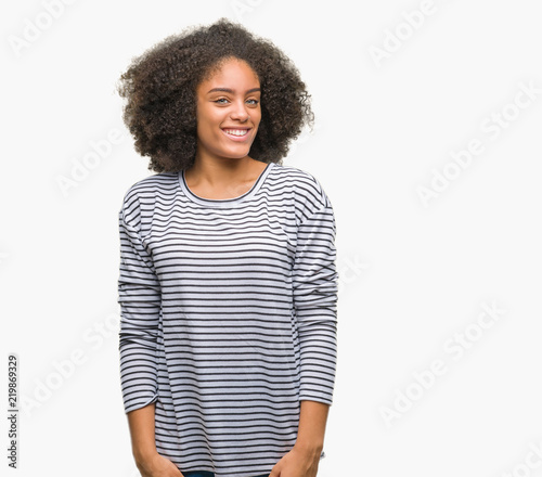 Young afro american woman over isolated background looking away to side with smile on face, natural expression. Laughing confident.