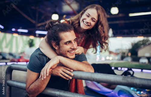 Young happy couple/ Young happy couple enjoying themselves at the amusement park