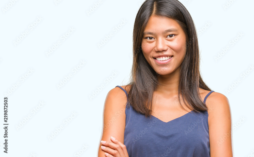 Young asian woman over isolated background happy face smiling with crossed arms looking at the camera. Positive person.