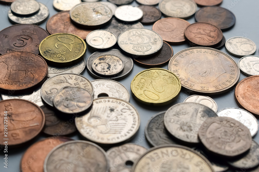 Modern and out of use coins of European countries. Selective or blurred focus with bright light. Modern and out of use coins of European countries. Selective or blurred focus with bright light.