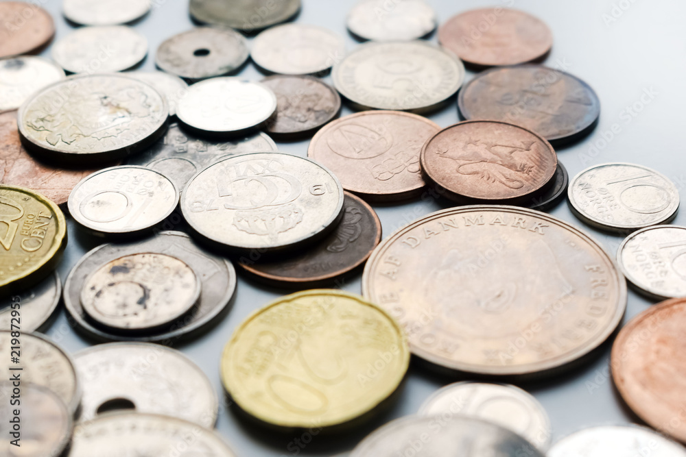 Modern and out of use coins of European countries. Selective or blurred focus with bright light. Modern and out of use coins of European countries. Selective or blurred focus with bright light.