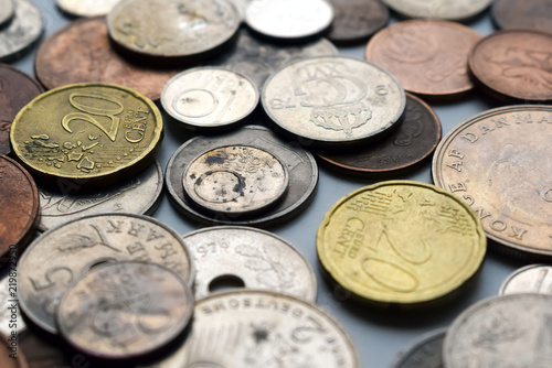 Modern and out of use coins of European countries. Selective or blurred focus with bright light.