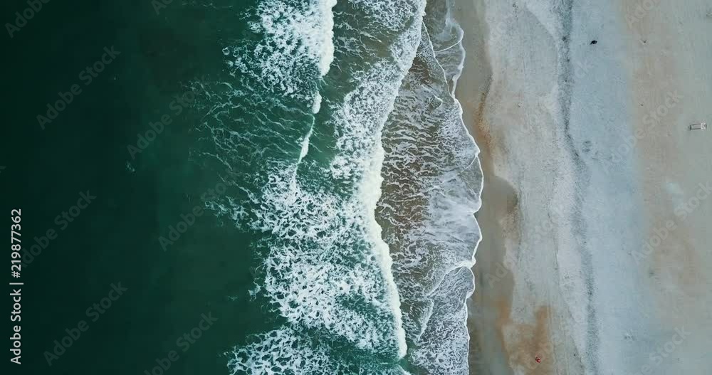 Overhead aerial, waves crash on beach in Wilmington Overhead aerial, waves crash on beach in Wilmington