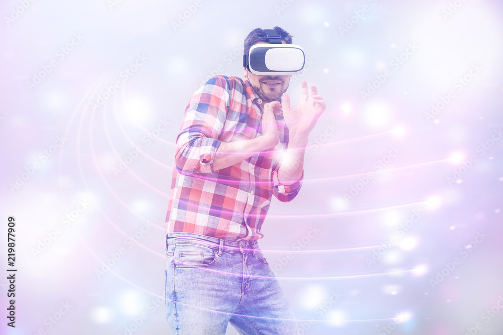 Man with virtual reality headset playing video game on light background, colorful effect. Leisure and entertainment Man with virtual reality headset playing video game on light background, colorful effect. Leisure and entertainment