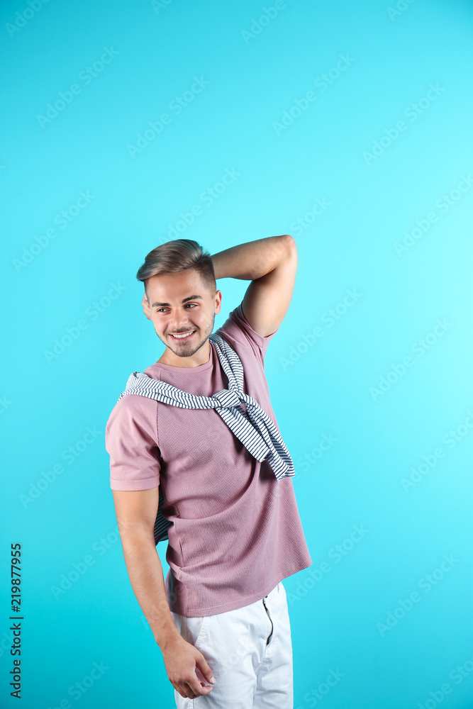 Young man with trendy hairstyle on color background Young man with trendy hairstyle on color background