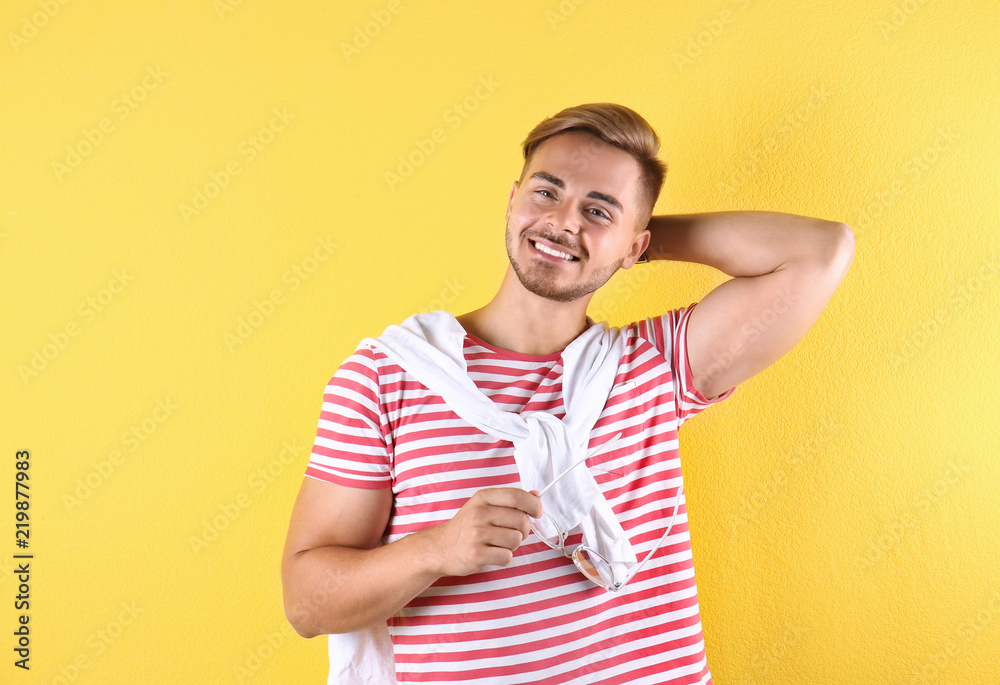 Young man with trendy hairstyle on color background Young man with trendy hairstyle on color background