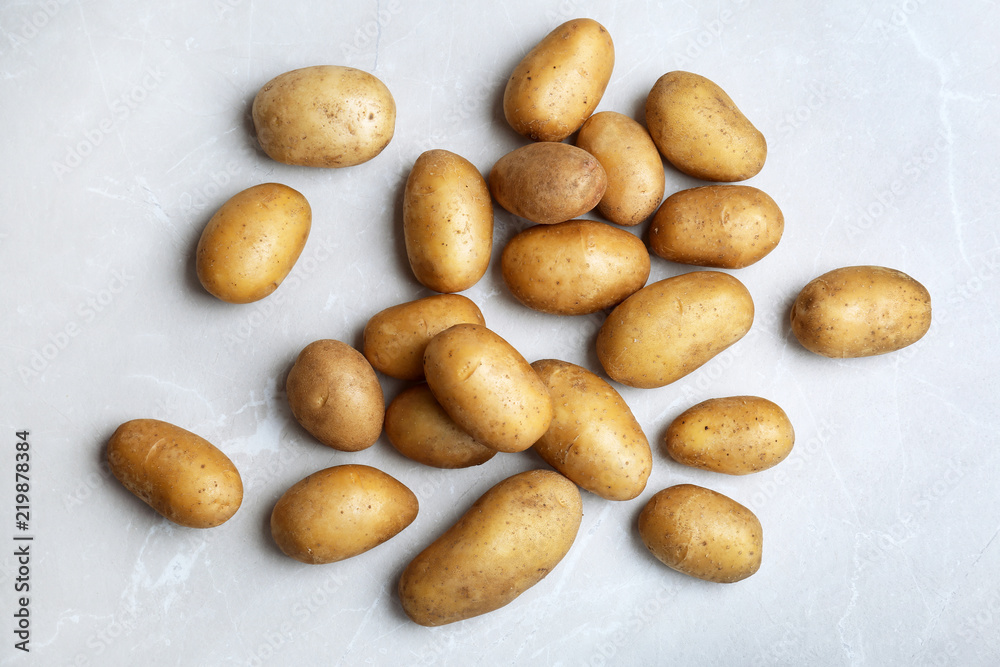 Fresh ripe organic potatoes on grey background, top view Fresh ripe organic potatoes on grey background, top view