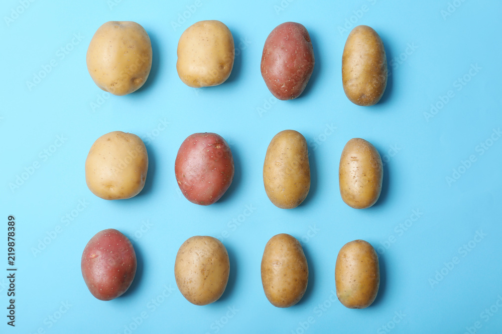 Flat lay composition with fresh organic potatoes on color background Flat lay composition with fresh organic potatoes on color background
