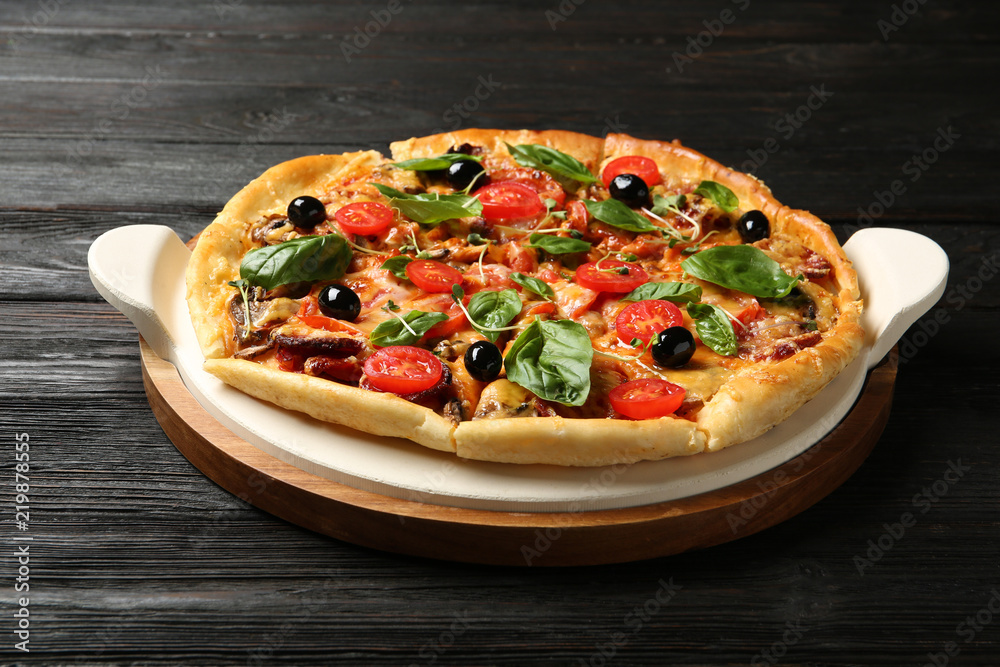 Tasty fresh homemade pizza on wooden table Tasty fresh homemade pizza on wooden table