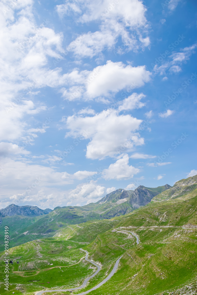 A winding road runs through the picturesque mountains.