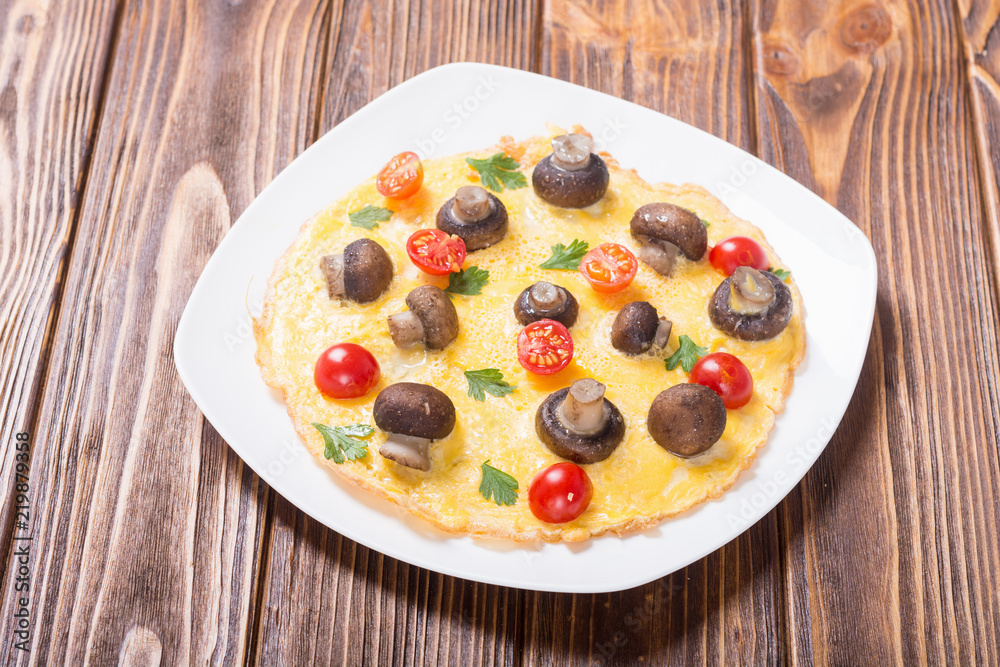 Omelette with mushroom , tomato and parsley Omelette with mushroom , tomato and parsley