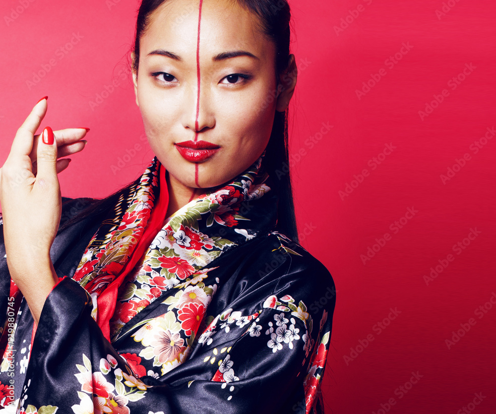 young pretty geisha on red background posing in kimono, oriental young pretty geisha on red background posing in kimono, oriental