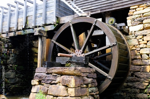 Fototapeta Closeup view of the flume and waterwheel of the old gristmill at Historic Yates