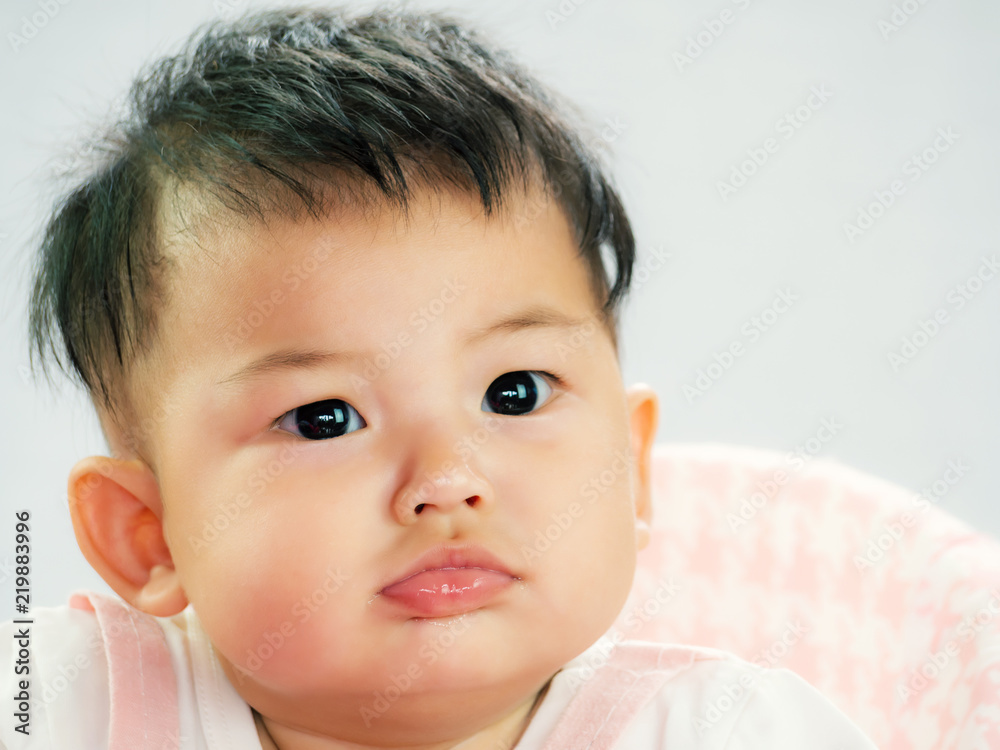 Portrait of cute short hair asia baby girl in soft color wearing and face doubt Portrait of cute short hair asia baby girl in soft color wearing and face doubt
