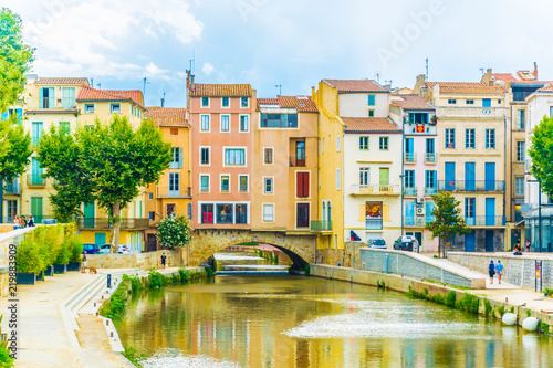 Canal de la robine flowing through the city center of Narbonne, France photo