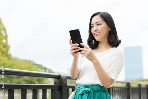 attractive asian woman relaxing in park
