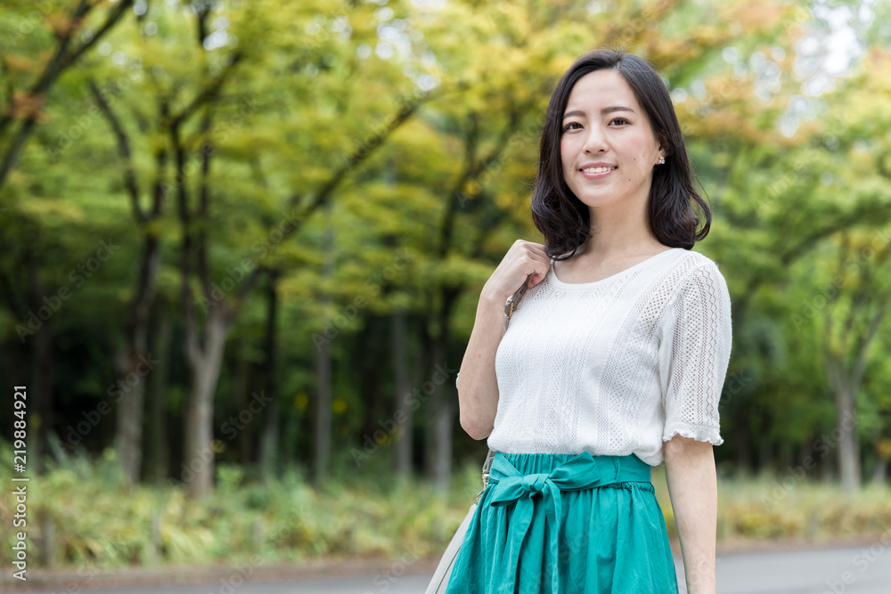 attractive asian woman relaxing in park attractive asian woman relaxing in park