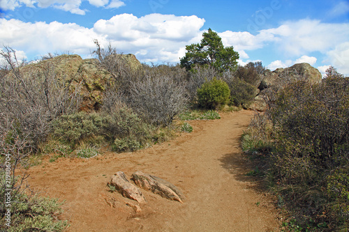 Walking trail in Black Canyon of the Gunnison National Park and recreation area at Painted Wall view, near Montrose, Colorado, USA with blue cloudy sky.
