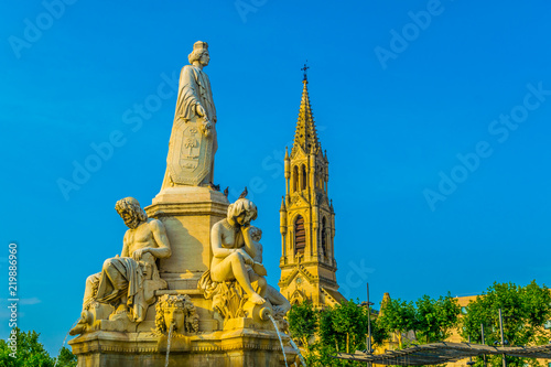 Church of Sainte Perpetue and fountain Pradier in Nimes, France photo