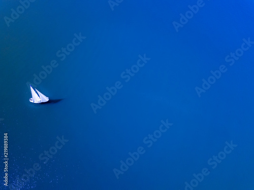 A single sailboat in the Blue Ocean