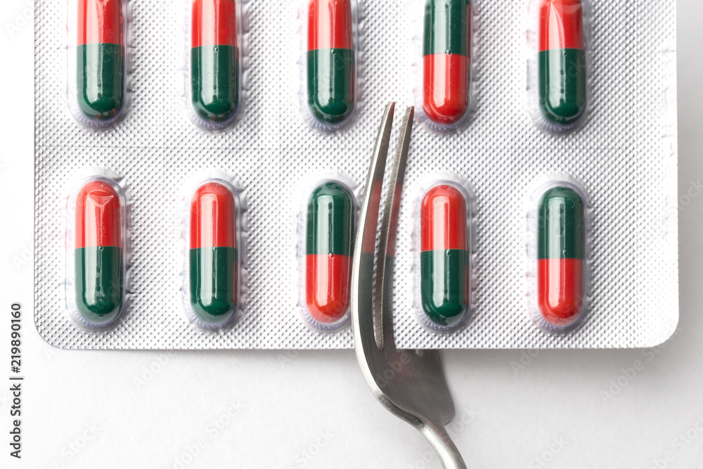capsules and pills with fork, diet and weight loss, idea. Pills taken with a fork capsules and pills with fork, diet and weight loss, idea. Pills taken with a fork